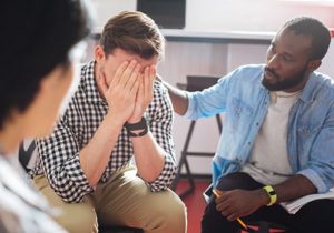 men open up about their struggles in therapy within a men's rehab program at an addiction treatment center