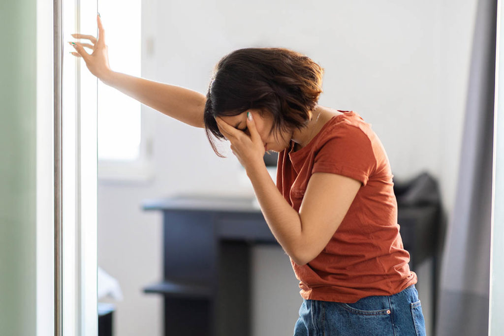 a woman struggles through heroin withdrawal without professional help trying not to relapse