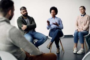 People sitting in chairs and talking to each other during a fentanyl addiction treatment program