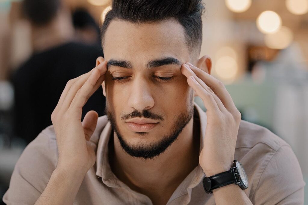 a man struggles to suppress his anger so as not to trigger his addiction