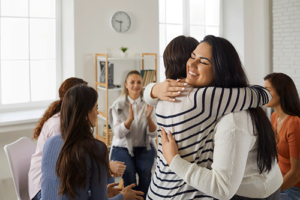 participants in an alcohol detox center therapy group support each other during a session