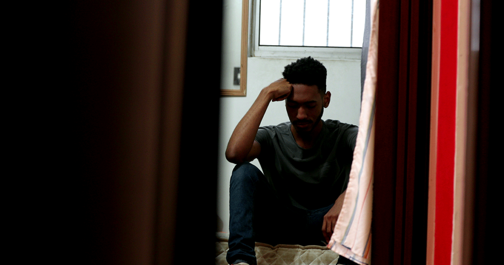 a man struggles to conceal his opioid addiction