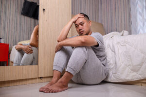 a young man looks ill and potentially is having an opioid overdose