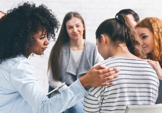 a therapy group meets in alcohol addiction treatment